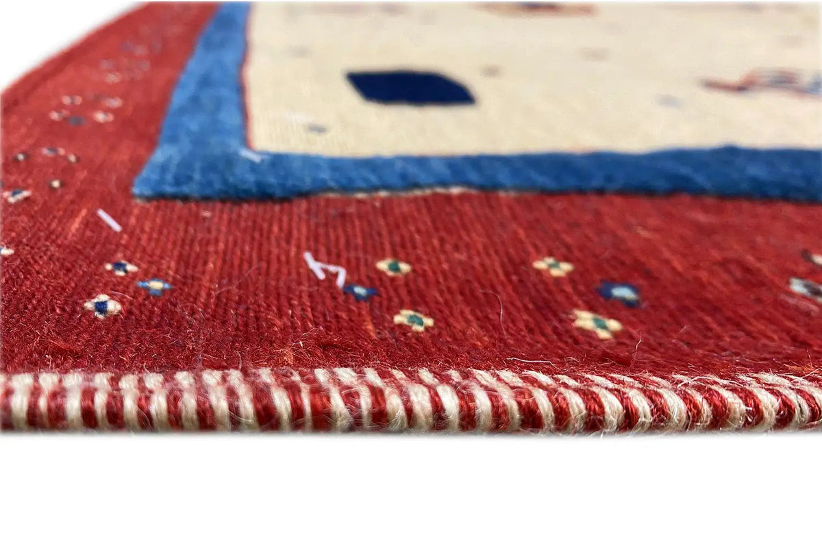 Close-up: red carpet edge with decorative fringe and multicolored border