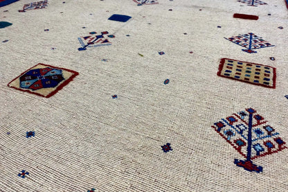 Detailed view of the patterns: beige fabric with blue and red designs