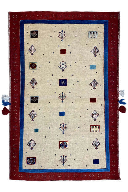 Beige rug with a red border, colorful ornaments, and tassels