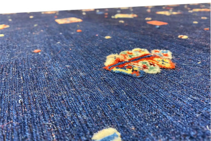 Soumak rug, detail: blue fabric with a colorful medallion pattern and texture