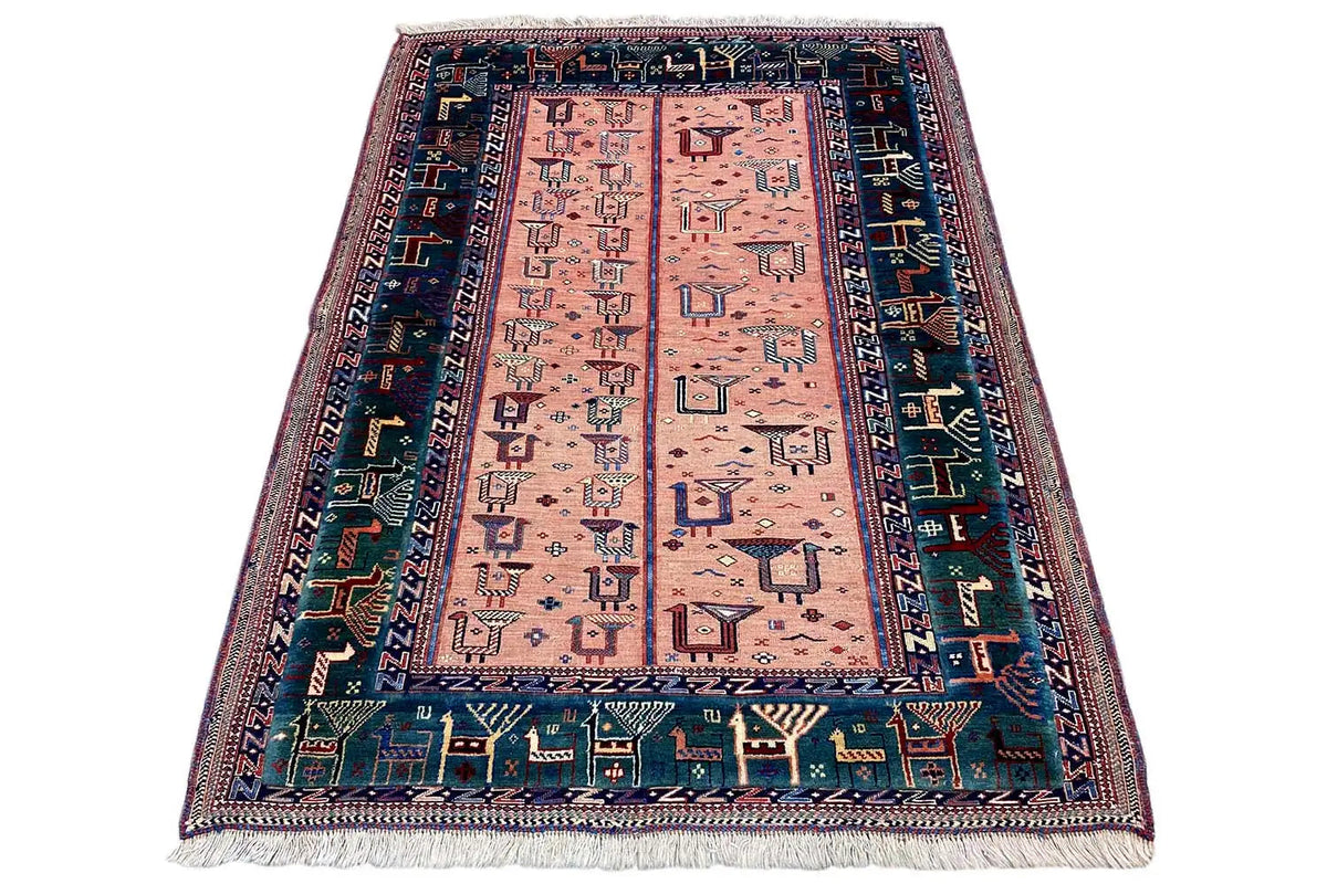 Rug with geometric medallion, pink-beige base, dark blue border, fringes