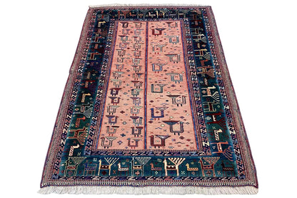 Rug with geometric medallion, pink-beige base, dark blue border, fringes