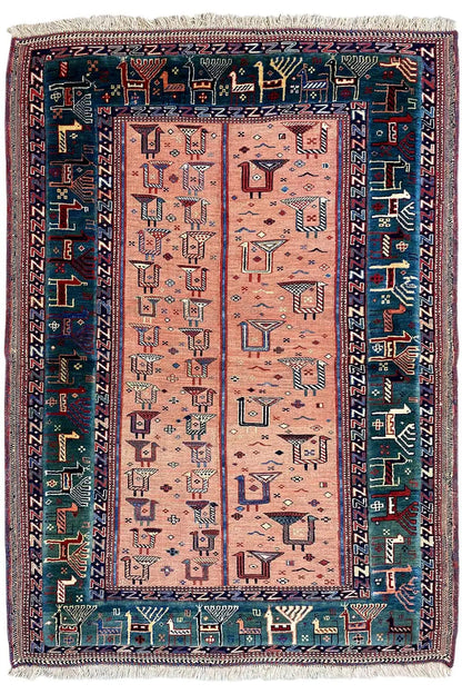 Rug with a rectangular central field, pink-beige background, blue patterned border, fringes
