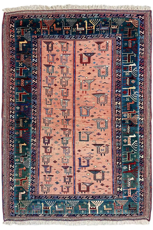 Rug with a rectangular central field, pink-beige background, blue patterned border, fringes