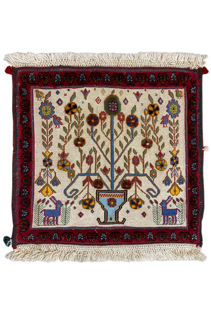 Decorative cushion cover with an all-over pattern, red trim, and tassels on the sides
