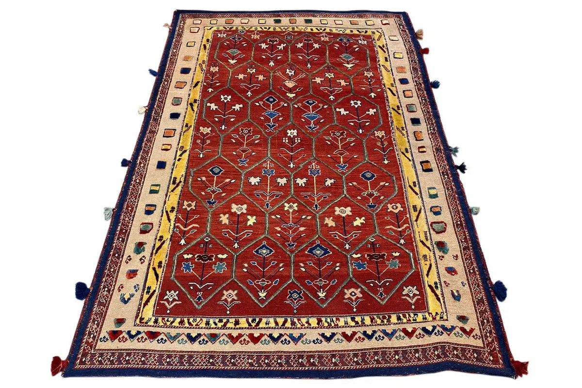 Reddish-brown Oriental rug with a wide border, blue edging, and tassels at the corners