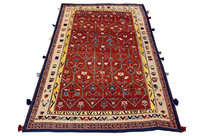 Reddish-brown Oriental rug with a wide border, blue edging, and tassels at the corners
