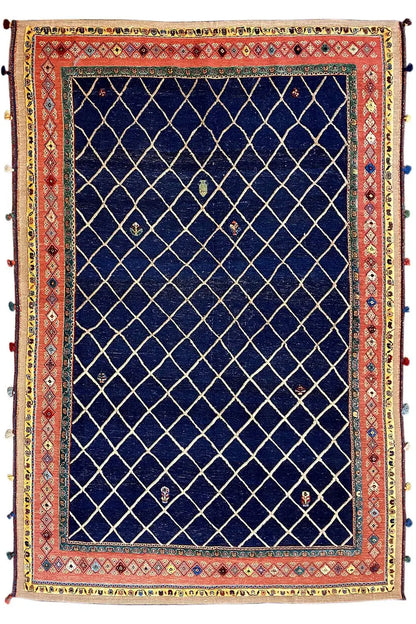 Rectangular rug with a dark blue grid pattern and red patterned borders