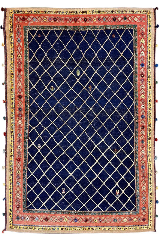 Rectangular rug with a dark blue grid pattern and red patterned borders