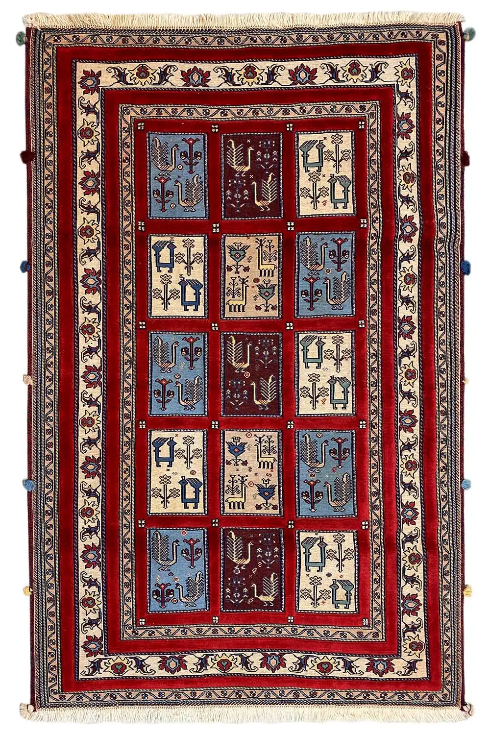 Rug with a central grid of red, blue, and beige motifs, wide border