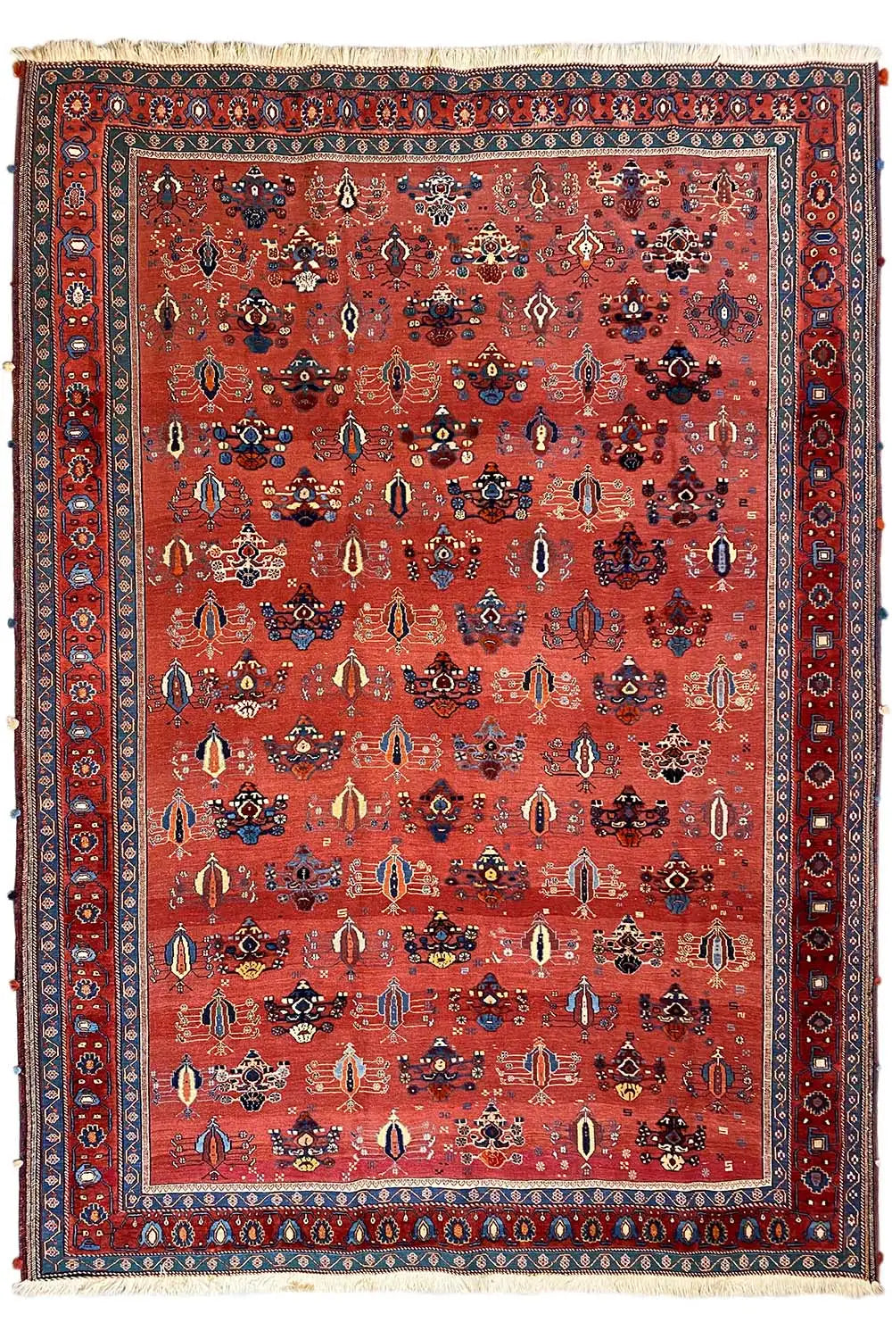 Red carpet with a detailed ornamental field and a wide blue border trim