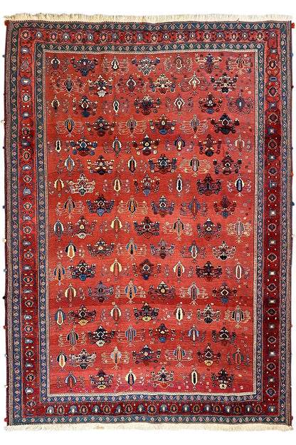 Red carpet with a detailed ornamental field and a wide blue border trim