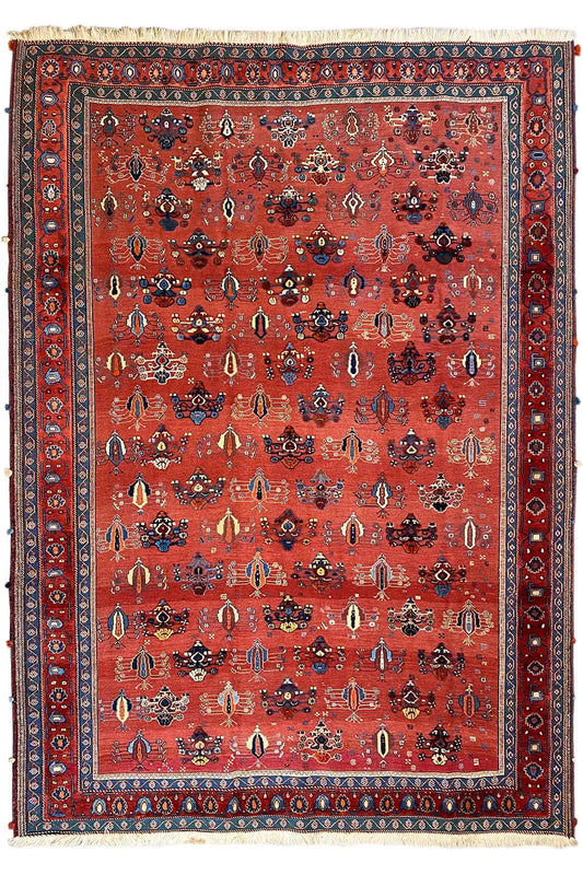 Red carpet with a detailed ornamental field and a wide blue border trim