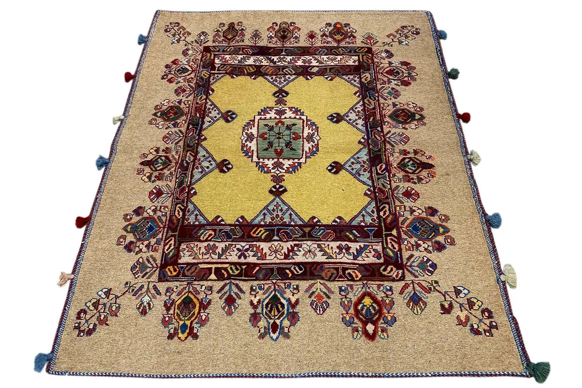 Soumakh rug 120x100 cm viewed from above: beige base with border, decorative frame, and corner tassels