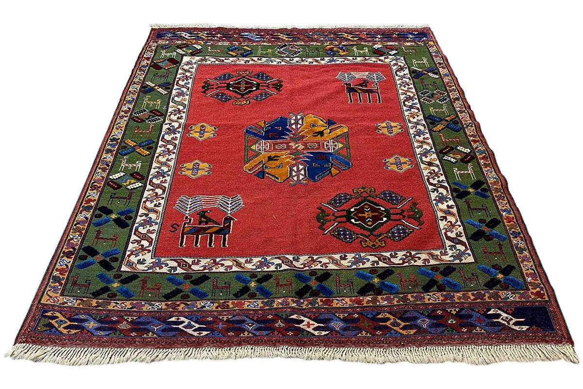 Rug with a red center and geometric motifs, colorful border, with fringes