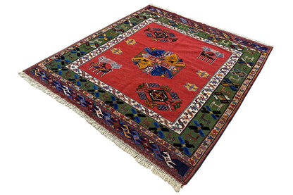 Rug with a red field, colorful figurative and patterned ornaments, and a colored border