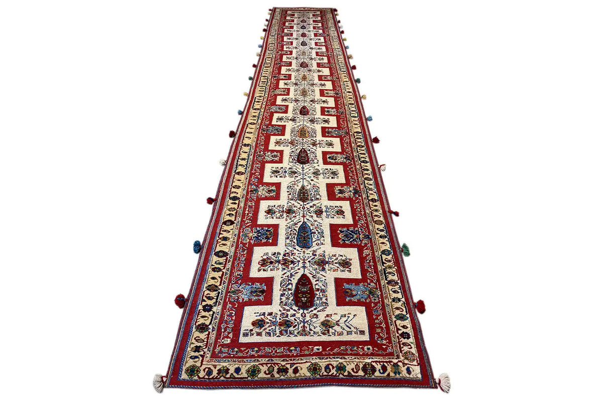 Oriental rug runner, tapering narrowly, red pattern with multicolored embellishments