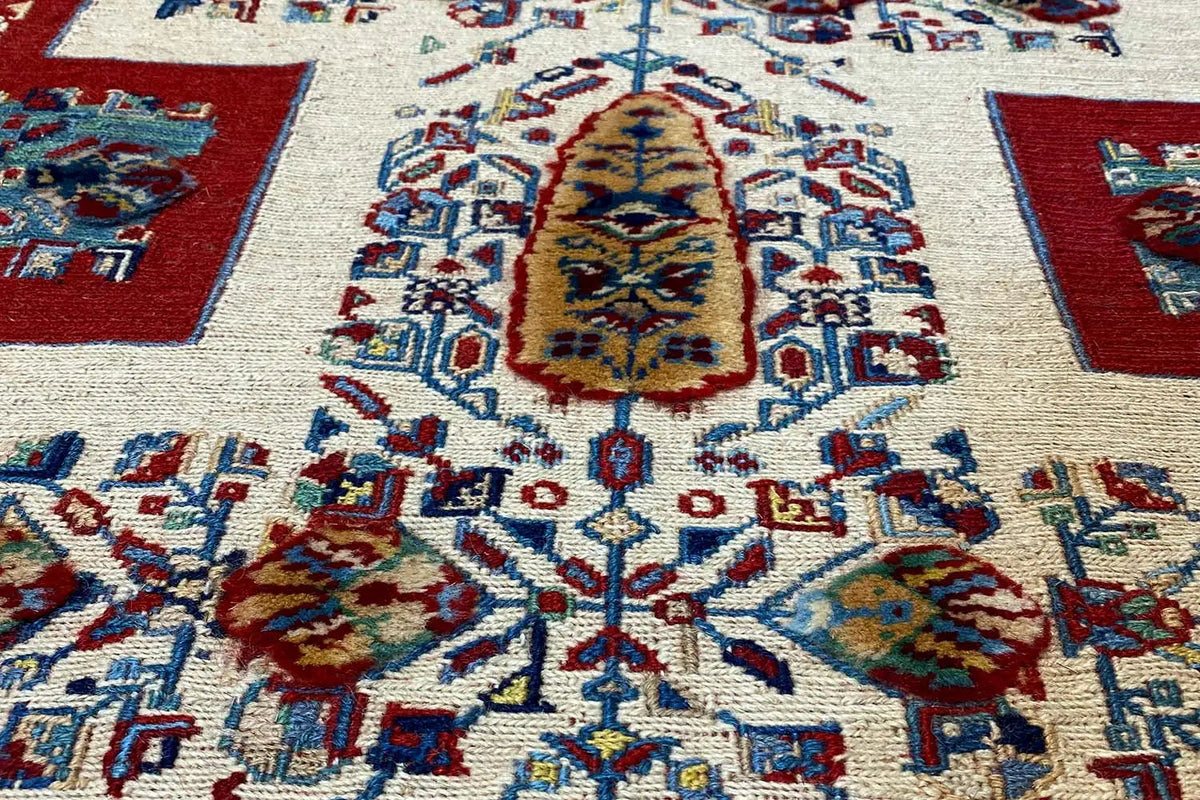 Oriental rug runner detail with large medallions in blue, red, and yellow