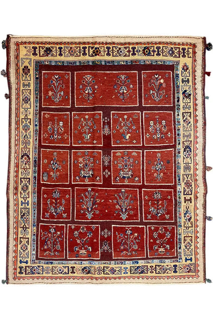 Square rug with a red tile pattern, blue inner border, and ornamental trim.