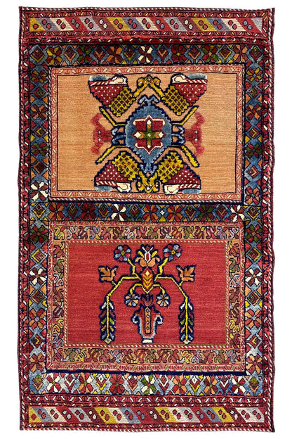 Oriental rug with a red ground, two rectangular ornamental fields, and multicolored borders, 135x83 cm