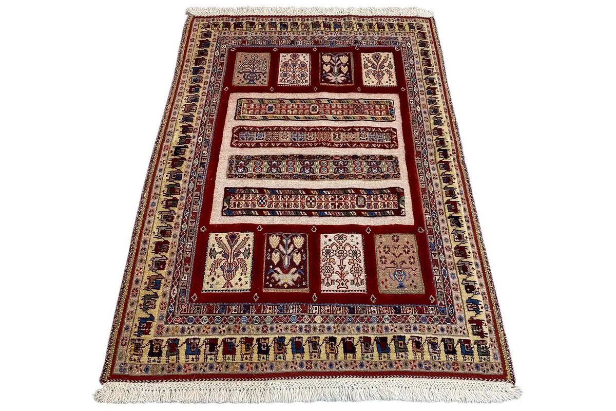 Oriental rug (139×103 cm) spread diagonally, red pattern with blue borders