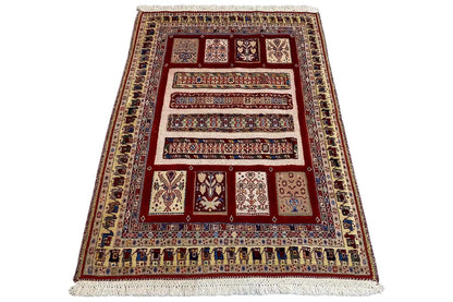 Oriental rug (139×103 cm) spread diagonally, red pattern with blue borders