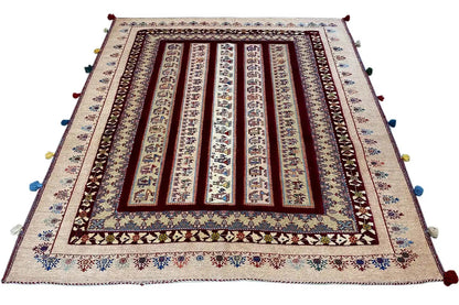 Soumak rug with a central framed pattern, beige background, multicolored tassels at the corners