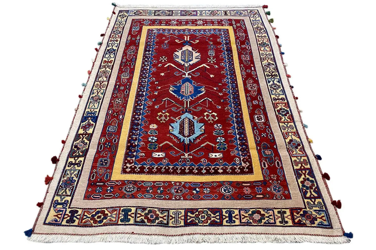 Oriental rug with a red longitudinal pattern, blue central border, and white fringed edge