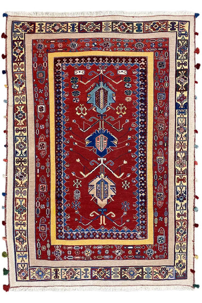 Oriental rug with a red central field, blue border design, and multicolored edging