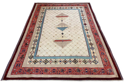 Rug laid flat: red inner border, beige field with blue decorative element