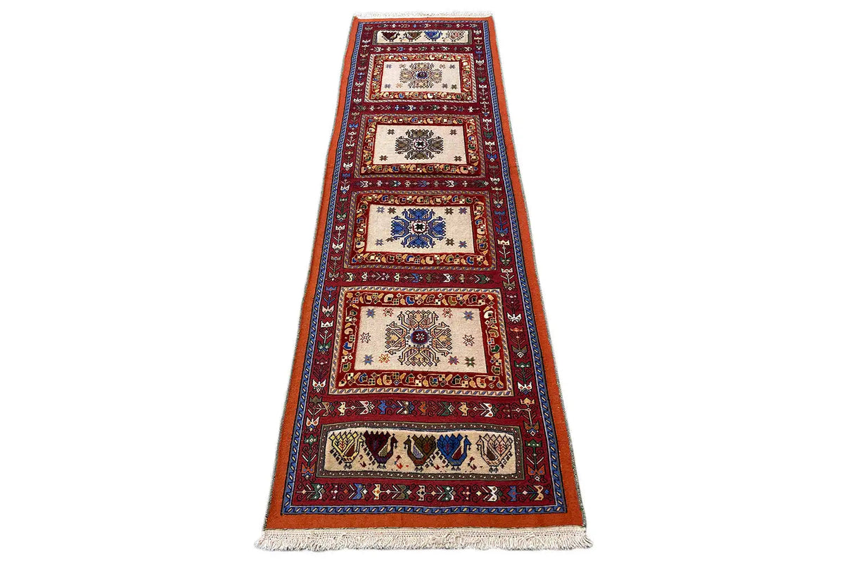 Runner rug with a minimalist zone pattern, red and blue with cream sections, fringes at the bottom.