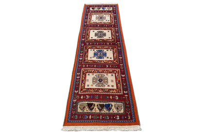 Runner rug with a minimalist zone pattern, red and blue with cream sections, fringes at the bottom.