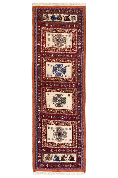 Long runner rug with a vertical stripe pattern in red, blue, and cream, with fringes at the top.