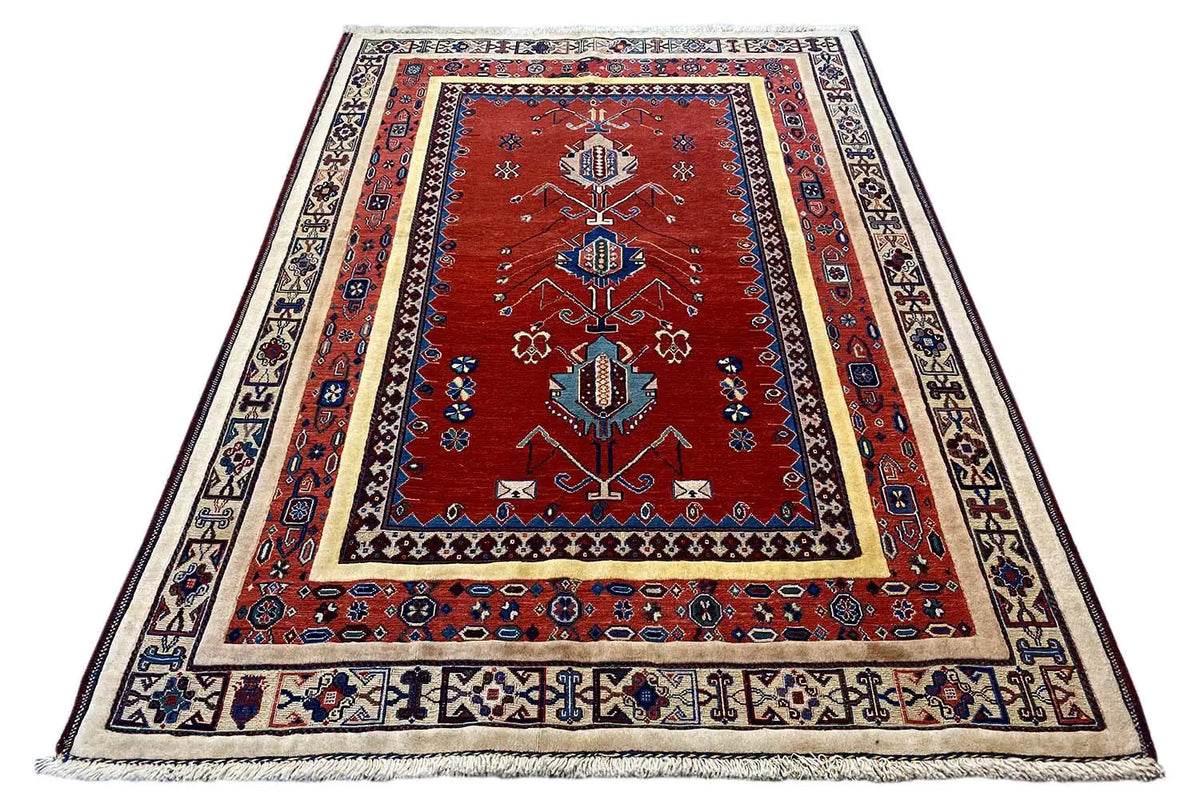 Rug (197x143 cm) with a red central medallion, blue ornamental design and fringes