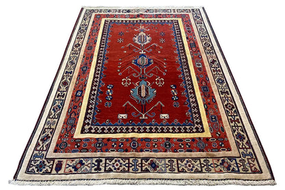 Rug (197x143 cm) with a red central medallion, blue ornamental design and fringes