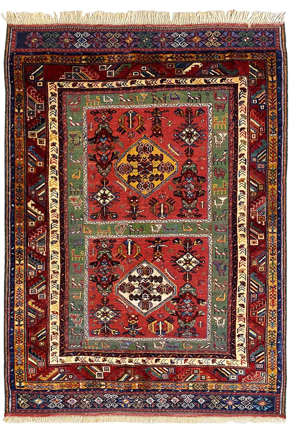 Reddish-brown Oriental rug with medallion, multicolored border, and fringe