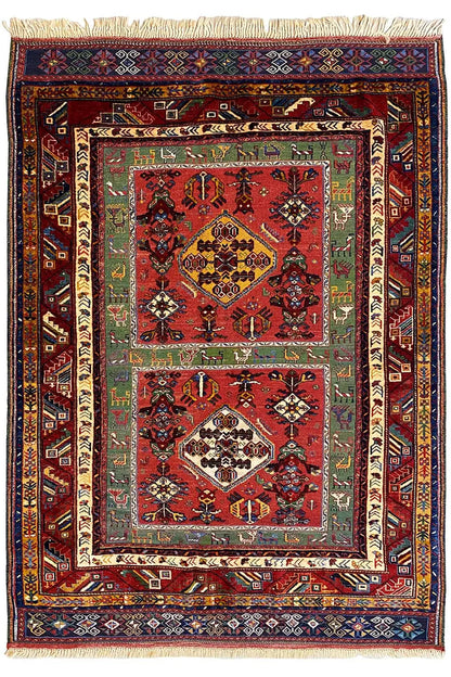 Reddish-brown Oriental rug with medallion, multicolored border, and fringe