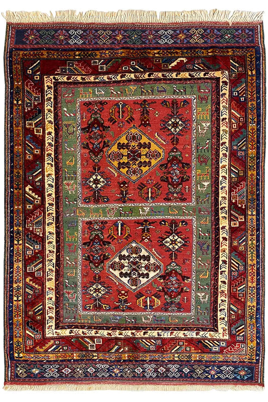 Reddish-brown Oriental rug with medallion, multicolored border, and fringe