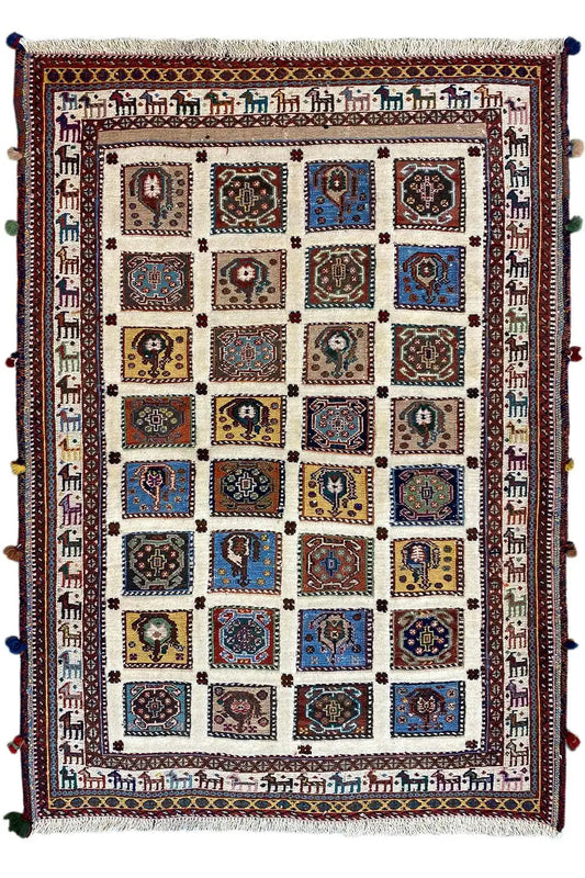 Rug with a square patchwork pattern of medallions in blue, red, and beige