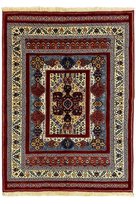Rug with a symmetrical square pattern, cream border, and multicolored ornaments