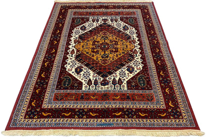 Soumak rug with a red background, geometric border design, and fringes