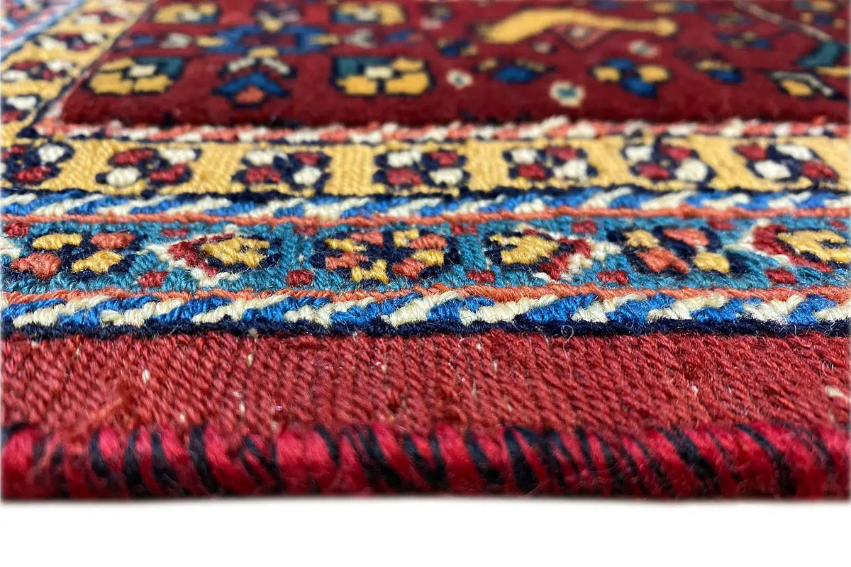 Soumak rug border with colorful patterns and fringe, close-up