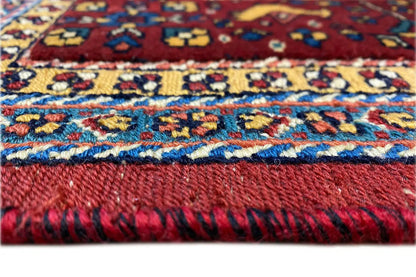 Soumak rug border with colorful patterns and fringe, close-up