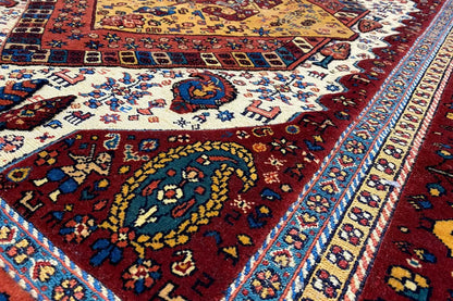 Soumak rug detail with a colorful pattern and turquoise border stripe
