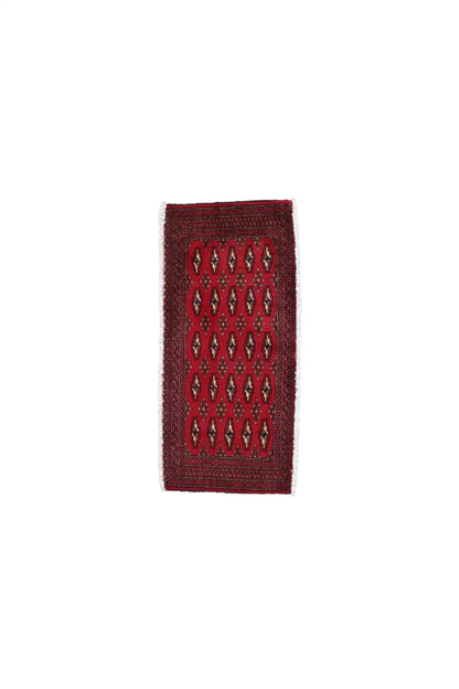 Turkmen carpet narrow section: red patterned field with a geometric design in dark blue