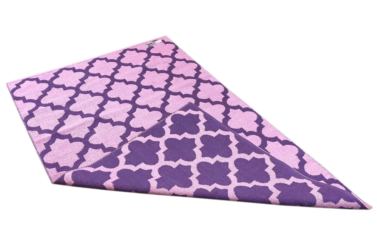 Modern purple kilim with a geometric pattern and visible edge, angled