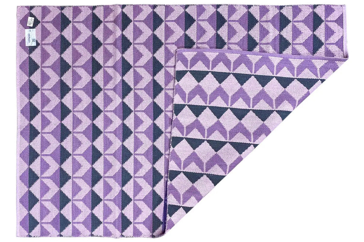 Kilim rug with a purple diamond pattern and border, folded edge