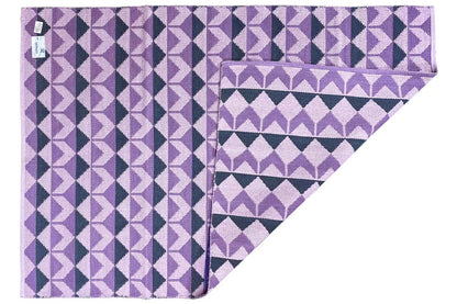 Kilim rug with a purple diamond pattern and border, folded edge