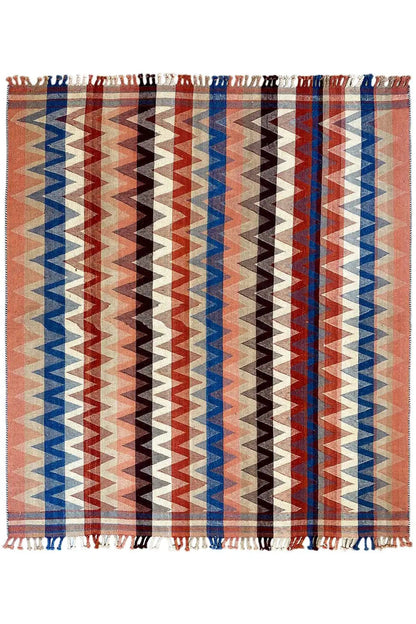 Terracotta rug with wide blue and brown zigzag stripes, fringes