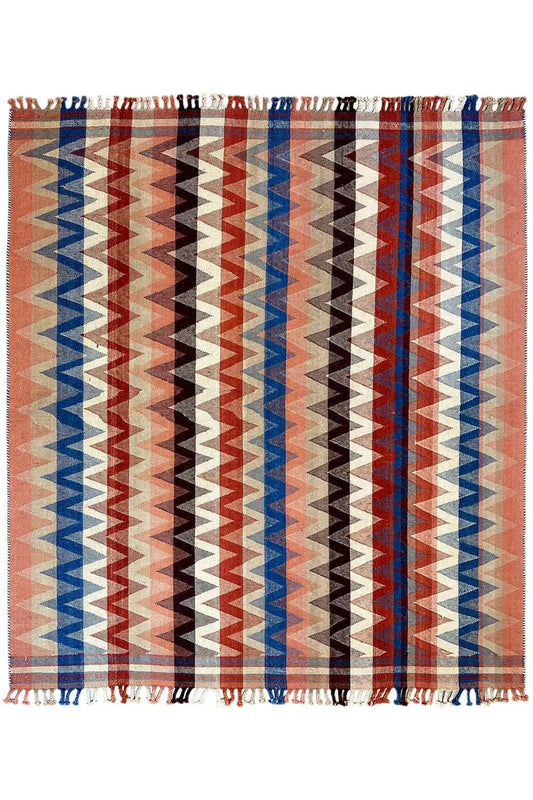Terracotta rug with wide blue and brown zigzag stripes, fringes